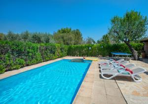 a swimming pool with lounge chairs and a table at Owl Booking Villa Can Gorreta - 5 Min Walk To The Old Town in Pollença