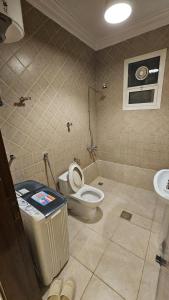 a bathroom with a toilet and a sink at Lamar 1 furnished Aparthotel in Riyadh