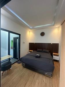 a bedroom with a bed and a table and a desk at alopa villas in Beran-kidul +70 photos