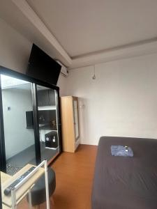 a room with a bed and a chair in it at alopa villas in Beran-kidul