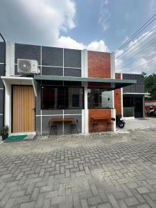 a building with a table in front of it at alopa villas in Beran-kidul