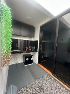 a kitchen with black cabinets and a large glass door at alopa villas in Beran-kidul +71 photos