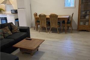 a living room with a couch and a table and chairs at Les Jardins du Soleil in Avignon