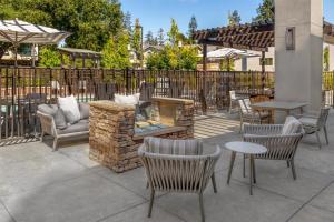 a patio with chairs and tables and a fire pit at Homewood Suites by Hilton Palo Alto in Palo Alto