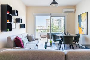 a living room with a couch and a table at Ondo 2-Bedroom Apartment in Larnaca