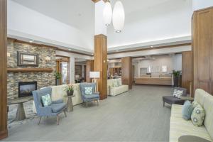 a living room with furniture and a fireplace at Hilton Garden Inn Clifton Park in Clifton Park