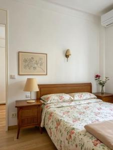 a bedroom with a bed and a table with a lamp at Reyan Homestay in Kohīma