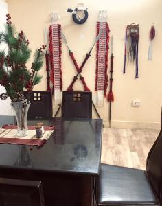 a room with a table with weapons on the wall at Reyan Homestay in Kohīma