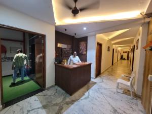 a man sitting at a bar in a restaurant at Hotel melbourne sky in New Delhi