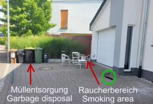 a patio with two chairs and a building at Unterkunft in Steinmauern in Steinmauern