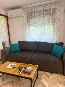 a living room with a couch and a coffee table at Apartament Draganovi 8B in Kazanlŭk +20 photos