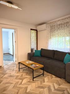 a living room with a couch and a coffee table at Apartament Draganovi 8B in Kazanlŭk