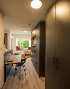 a kitchen with a table and a dining room at Sattler Living Apartments in Ebbs +8 photos