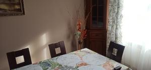 a dining room with a table and two chairs at Apartament u Basi in Sanok