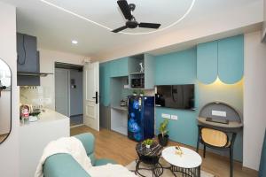 a living room with a couch and a kitchen at UHomes Pune airport in Pune