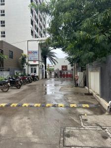 a parking lot with motorcycles parked in front of a building at UHomes Pune airport in Pune