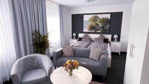 a living room with a bed and a couch at Hotel Pension Haus Talblick Edersee in Hemfurth-Edersee