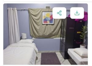 a small bedroom with two beds and a window at RestHaus in Goodwood