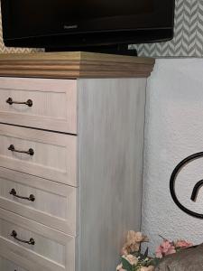a dresser with a television on top of it at Apartment Jelka 1 lux in Umka