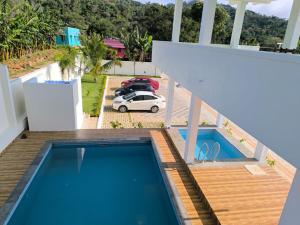 a view of a swimming pool from the balcony of a house at Chill Breeze Paradise in Yelagiri
