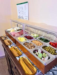 a buffet with different types of food on a table at Hotel Boutique Casón De Los López in Toledo