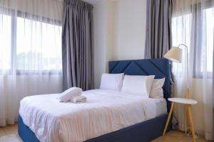 Postel nebo postele na pokoji v ubytování CasaNova Airport Suites