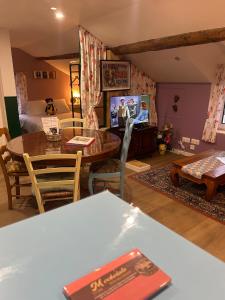 a living room with a table and a room with a bed at Chez Monica in Hayange