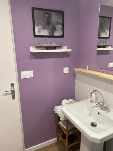 a purple bathroom with a sink and a mirror at Chez Monica in Hayange +23 photos
