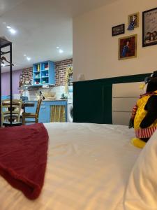 a bedroom with a large bed and a kitchen at Chez Monica in Hayange