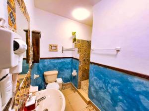 a bathroom with a toilet and a sink at Beachfront Apartment Hacienda del Cuyo in El Cuyo +38 photos