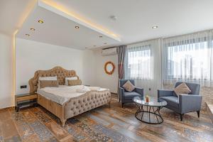 a bedroom with a bed and two chairs and a table at Casa Rosa Luxury Villa w heated Pool in Belek +38 photos