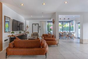 a living room with two couches and a dining room at Casa Rosa Luxury Villa w heated Pool in Belek