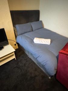 a bed with a towel on top of it in a room at Snug Studio - Minutes Walking from Pleasure Beach - Burlington Road in Blackpool