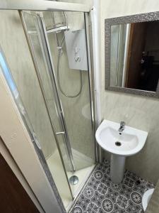 a bathroom with a shower and a sink at Snug Studio - Minutes Walking from Pleasure Beach - Burlington Road in Blackpool