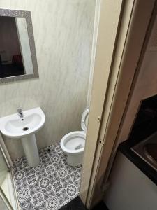 a bathroom with a white toilet and a sink at Snug Studio - Minutes Walking from Pleasure Beach - Burlington Road in Blackpool