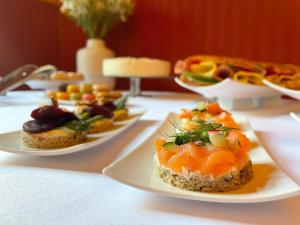 a table with three plates of food on it at Zlatý Lev Žatec in Žatec