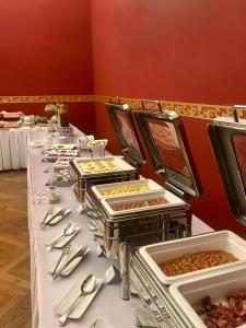 a buffet line with plates of food on a table at Zlatý Lev Žatec in Žatec +30 photos