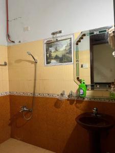 a bathroom with a shower and a sink at Khách sạn Hội An - Kon Tum in Kon Tum