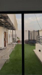 a view from a window of a patio with green grass at La Belle Escale in Pikine