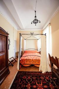 a bedroom with a bed with a canopy at Rinascimento Suite Centro Storico Modena in Modena