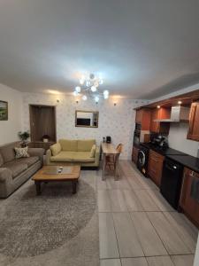 a living room with a couch and a table at Ulverston Town Centre Ground Floor Apartment in Ulverston