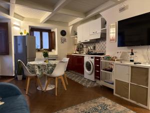 a kitchen with a table with chairs and a kitchen with a stove at Gloria Suite Catania in Catania
