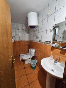 a bathroom with a toilet and a sink at My Rooms Hotel in Tirana +73 photos