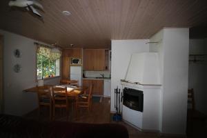 a kitchen and dining room with a table and chairs at Strandkulla in Svalskulla