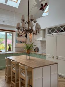 a kitchen with a table with chairs and a chandelier at Villa Pippi in Tokarnia