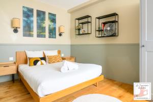 a bedroom with two beds and two mirrors at Joli gîte centre historique de Milly 2-4 personnes in Milly-la-Forêt