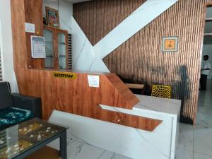 a stairway in a building with a sign that says reception at Hotel O New anugraha deluxe in Kulurkudrū