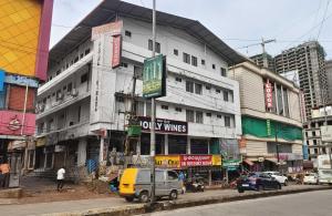 a building on the side of a city street at Hotel O New anugraha deluxe in Kulurkudrū
