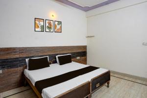 a bedroom with a bed in a room at Hotel O Radha Residency in Badarpur