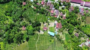 an overhead view of a house with a yard at Mawas Guest House Only Book Trekking With Us in Bukit Lawang +5 photos